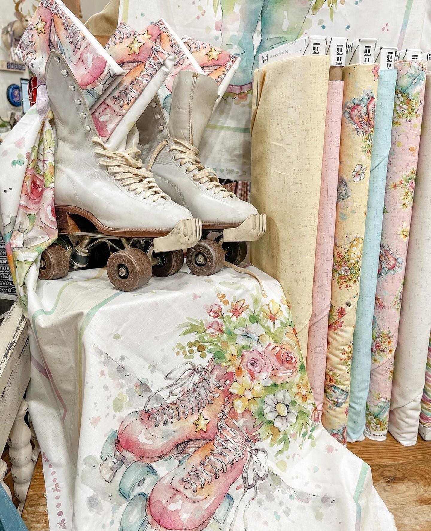 Picture of beautiful pastel floral fabric with skates sitting on top of a panel with skates and flowers.