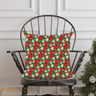 Peppermint Christmas pillow in chair with cups, birds and fruit.