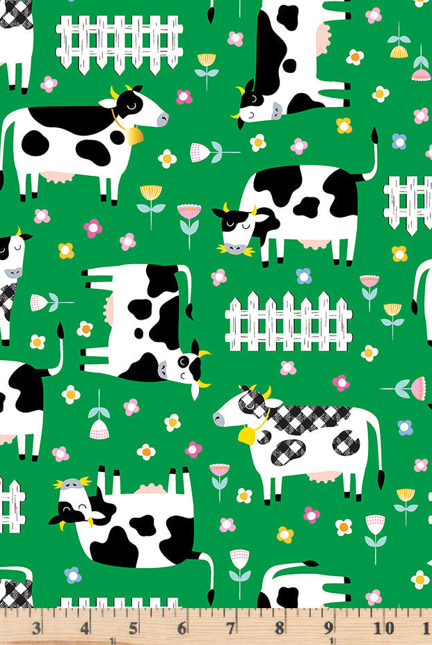 Green and white cows and white picket fences tossed on red 100% cotton fabric.  Barnyard Rules Moo Crew Green.