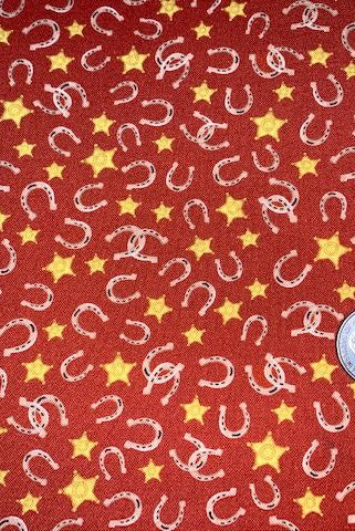 Little horseshoes and gold stars tossed on red fabric.  Country Rodeo Horseshoes Red